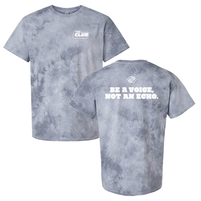 Front and back of a silver tie-dye t-shirt. The front features “The Club” logo on the chest, and the back displays the phrase “Be a voice, not an echo.” in bold white lettering below the Boys & Girls Clubs emblem.