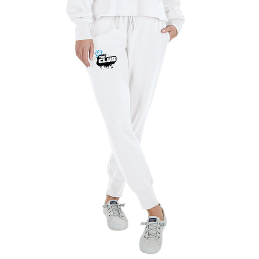 Front view of a person wearing white joggers with a drawstring waist and ‘The Club’ graffiti-style logo on the left thigh.