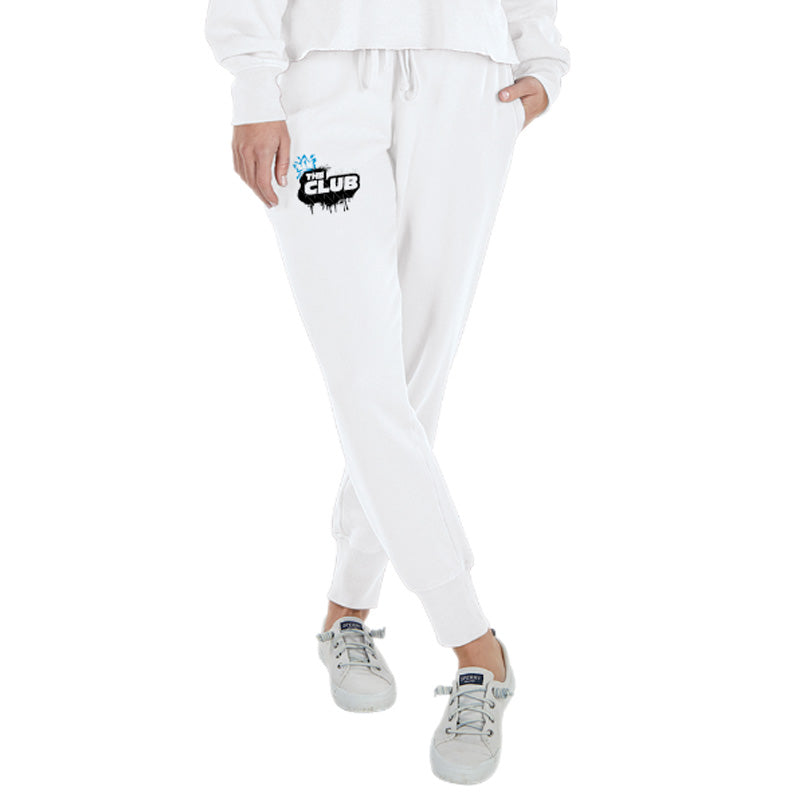 Front view of a person wearing white joggers with a drawstring waist and ‘The Club’ graffiti-style logo on the left thigh.