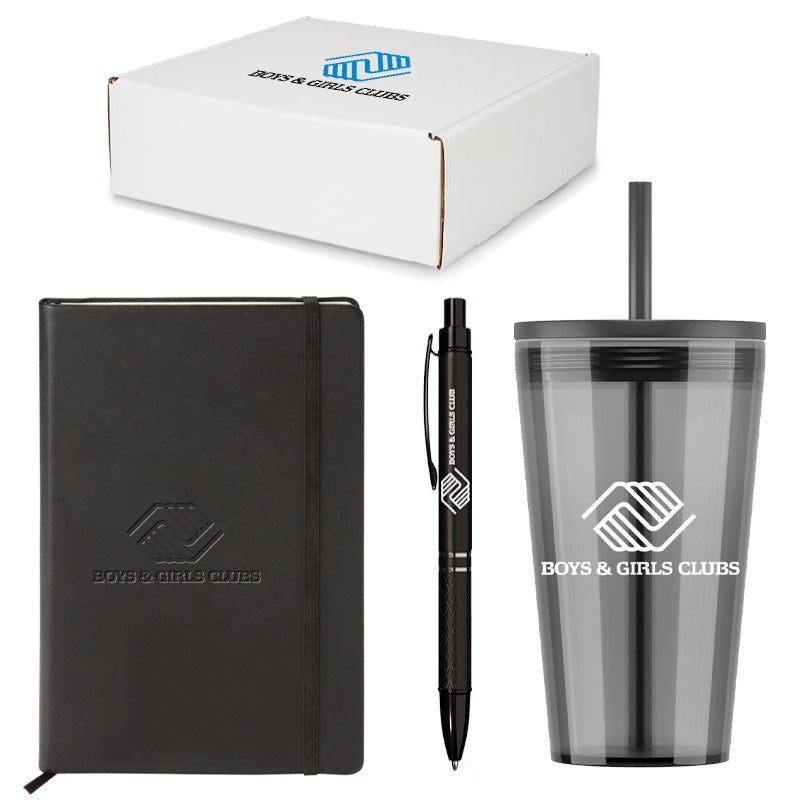 Three-piece gift set including a black notebook with embossed Boys & Girls Clubs logo, a matching black pen, and a translucent black tumbler with straw and white logo, all packaged in a white branded gift box.